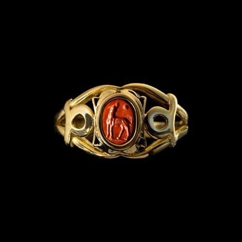 A modern gold ring set with a Roman red jasper intaglio. Dog.